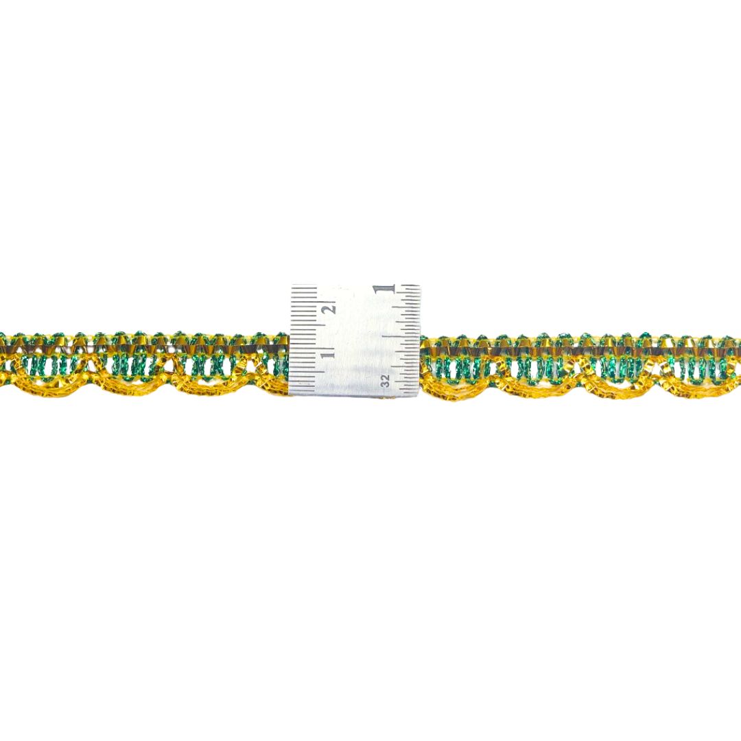 Decorative trim with gold and green pattern next to a ruler on a white background